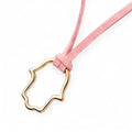 Ofek Adler Oua jewelry large gold-plated hollow hamsa pendant on a soft pink suede cord necklace