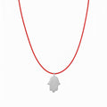 אופק אדלר אואה תכשיטים SANTA men's necklace featuring a large sterling silver hamsa pendant on a red cord.